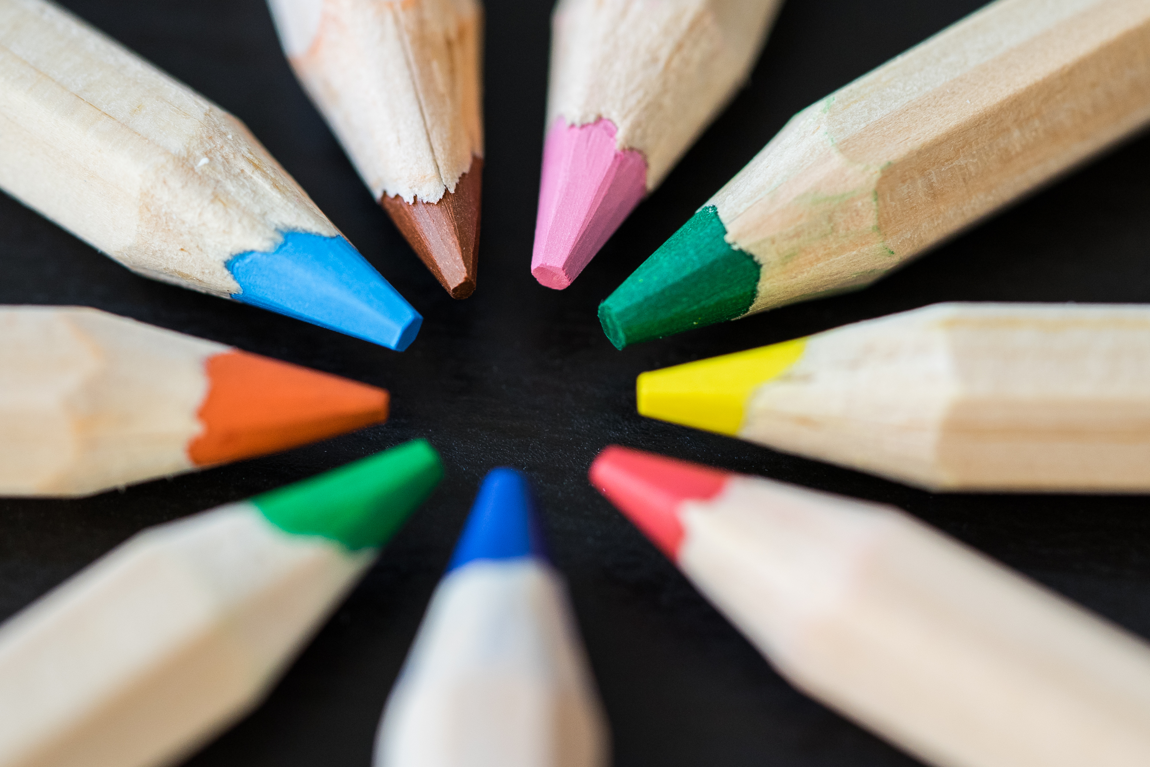 colored-pencils-in-a-circle-on-a-black-desk-picjumbo-com.jpg